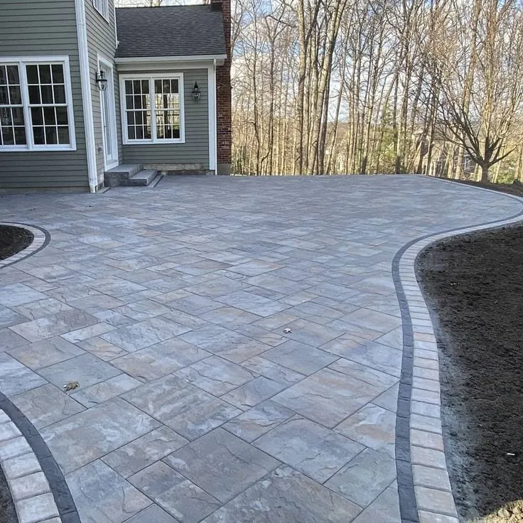 Blended-gray flagstone-look paver patio with charcoal soldier border
