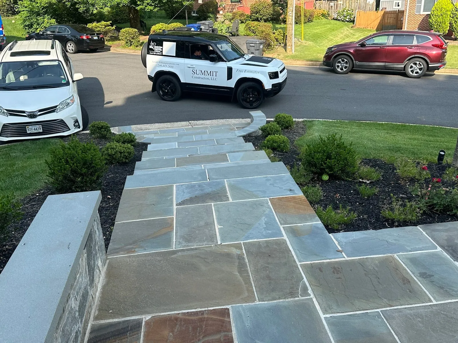 Bluestone walkway with stacked-stone cheek walls and Summit Land Rover
