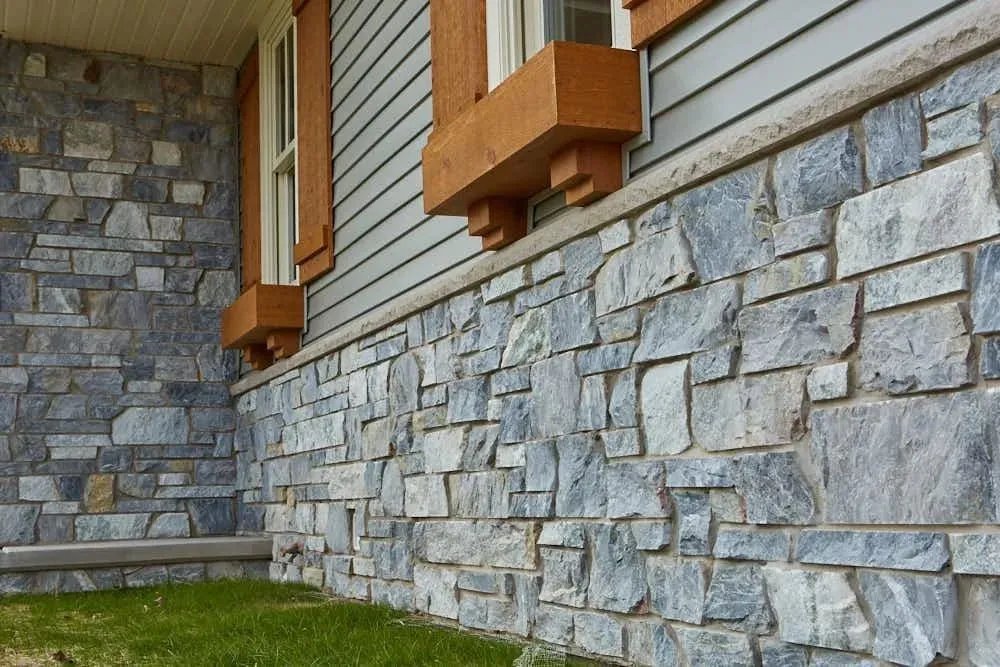 Blue-gray stone veneer wainscot with cedar window boxes